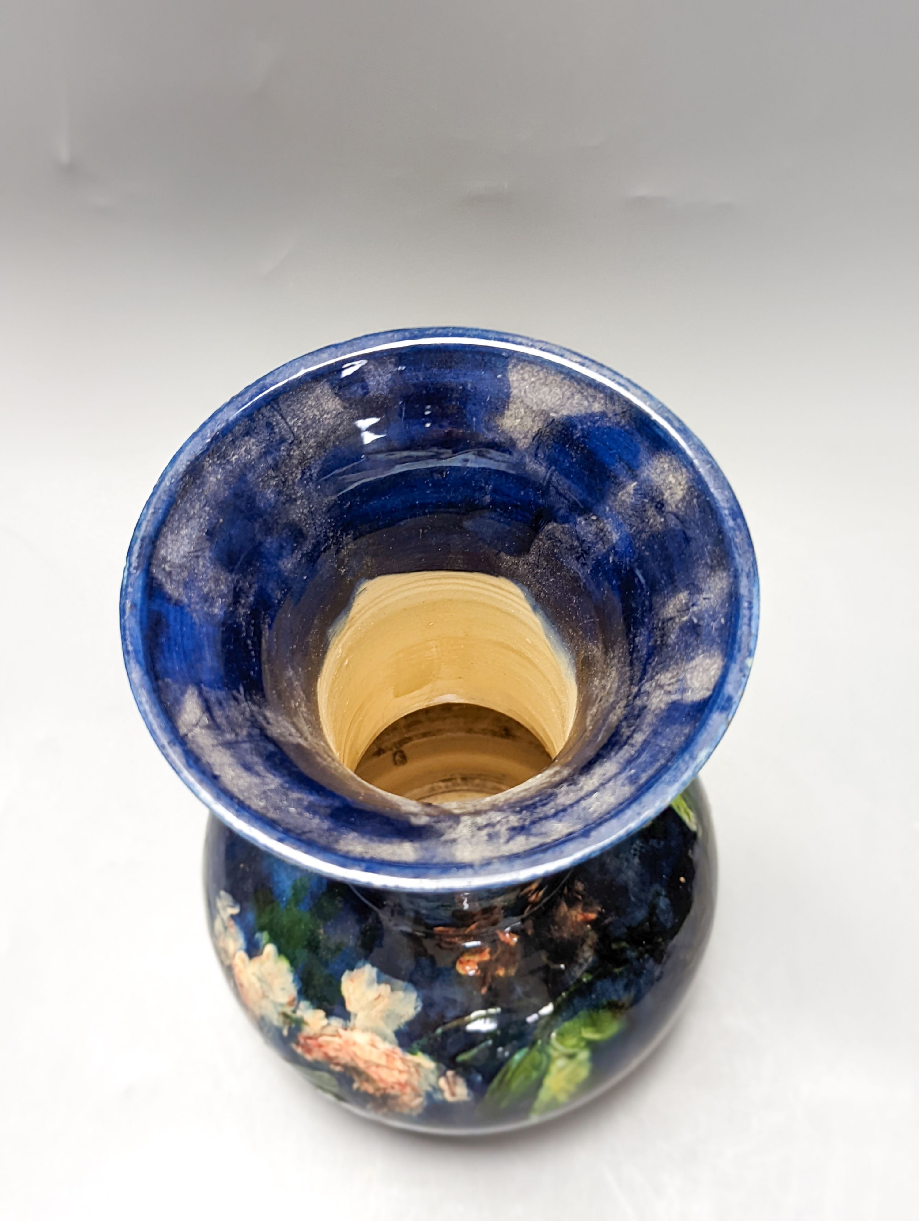A continental floral painted vase, possibly Belgian. Stamped to underside. 26cm